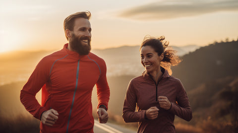 couple running in the mountains smiling and healthy celebrating longevity and wellness